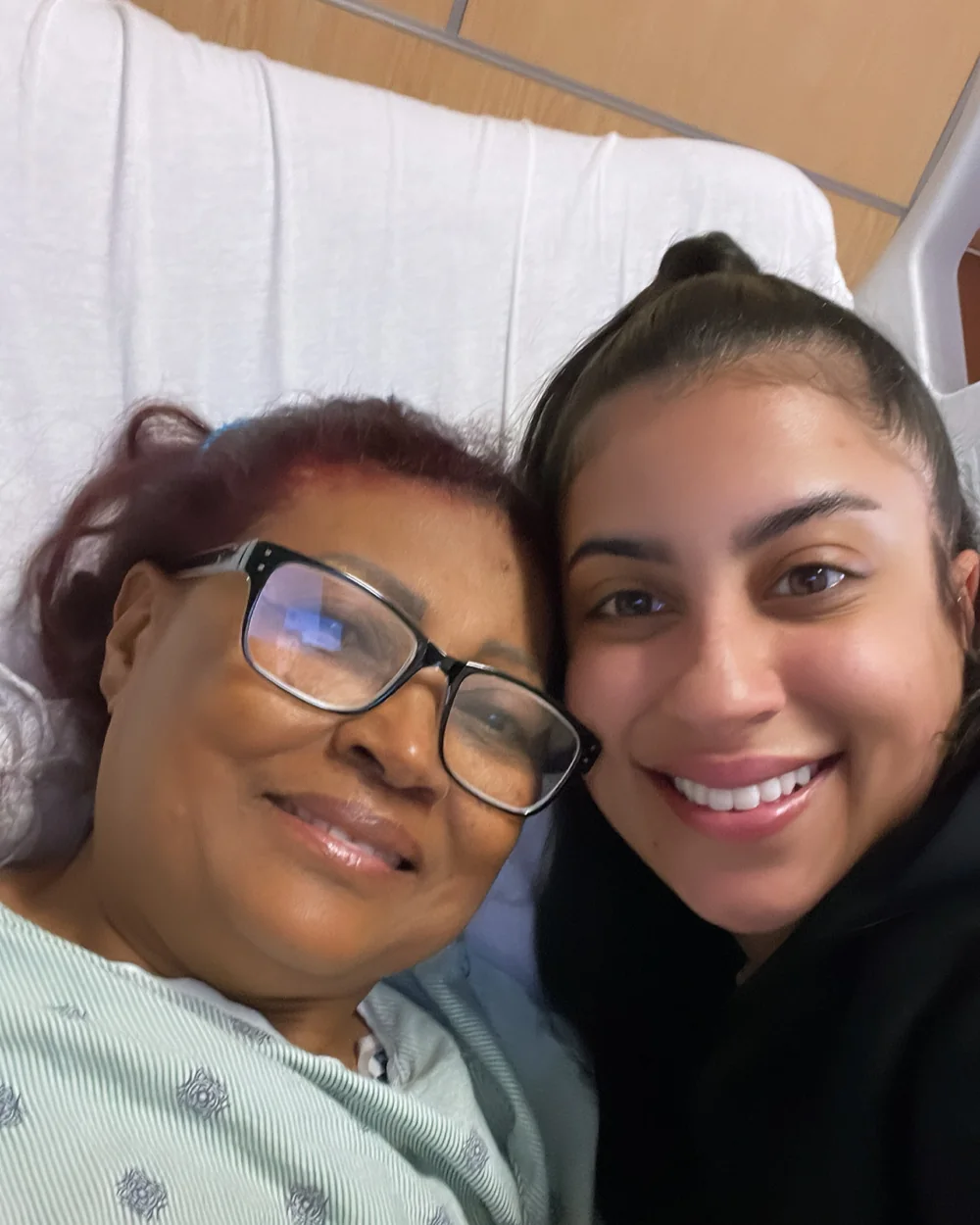 Rossy M. Peralta beside her mother in her hospital bed